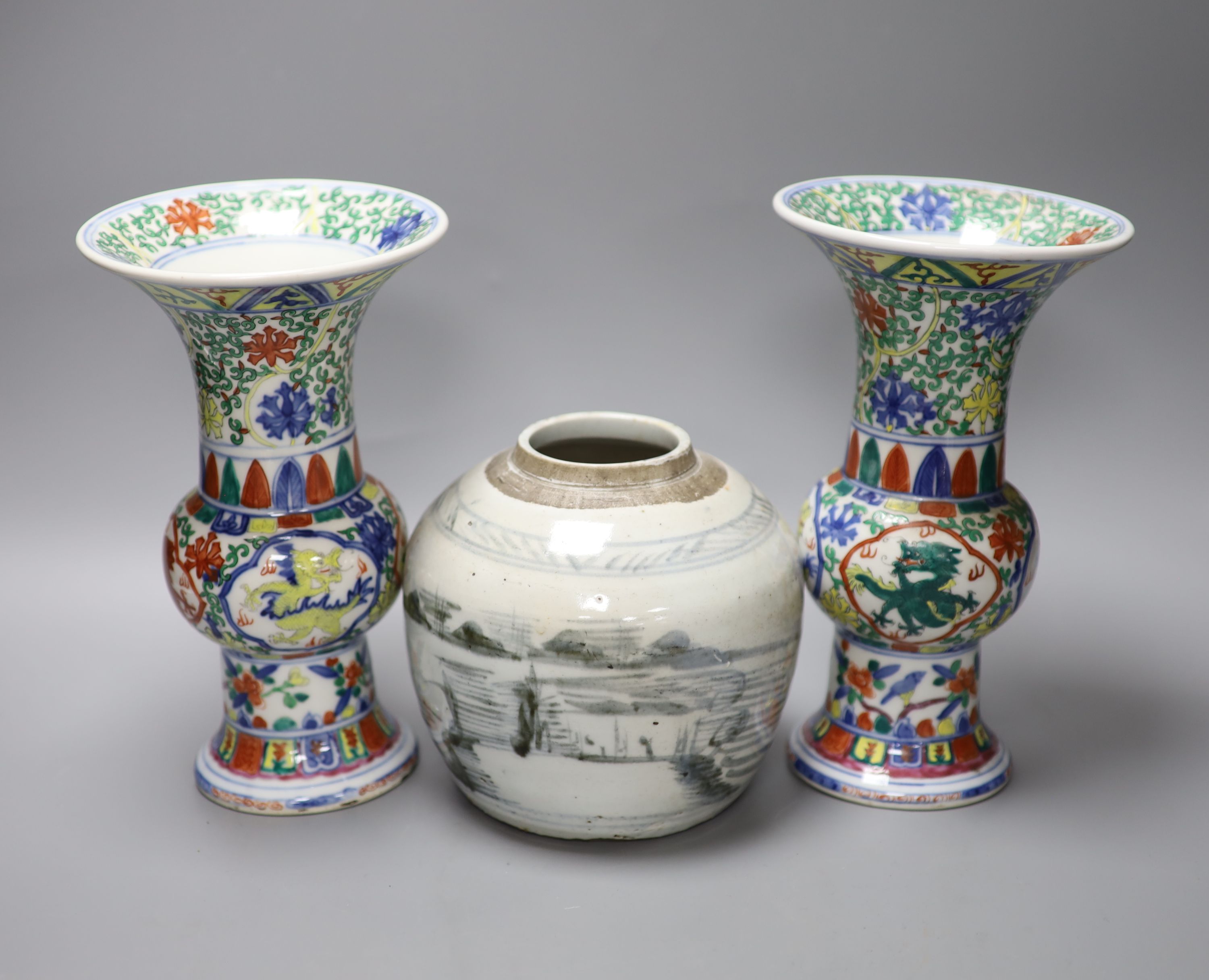 A pair of Chinese famille verte vases, height 24cm, and a jar